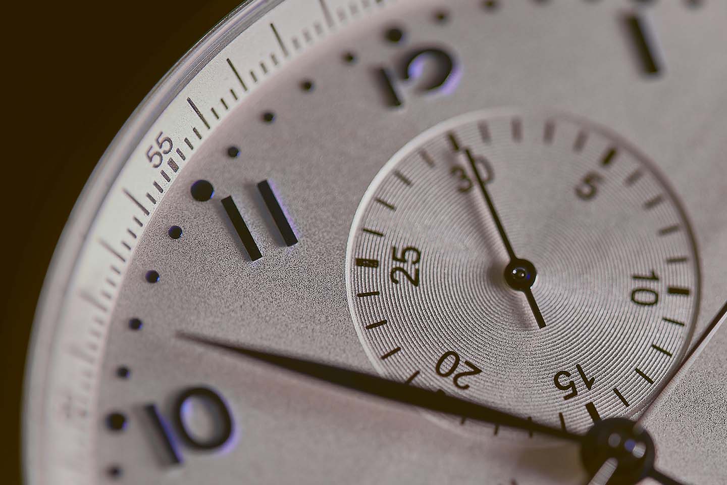 A close up of a silver watch face