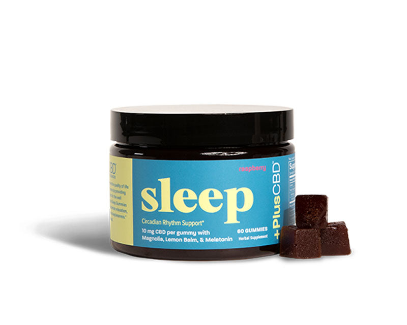 a jar of +PlusCBD Sleep Gummies in Raspberry flavor beside three dark brown gummies