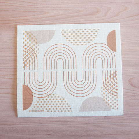 Swedish dishcloth with terracotta pattern on laying on wood surface