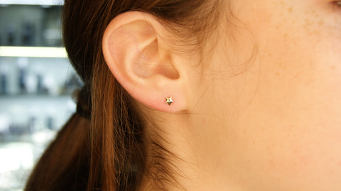 Lobe piercing with a gold star