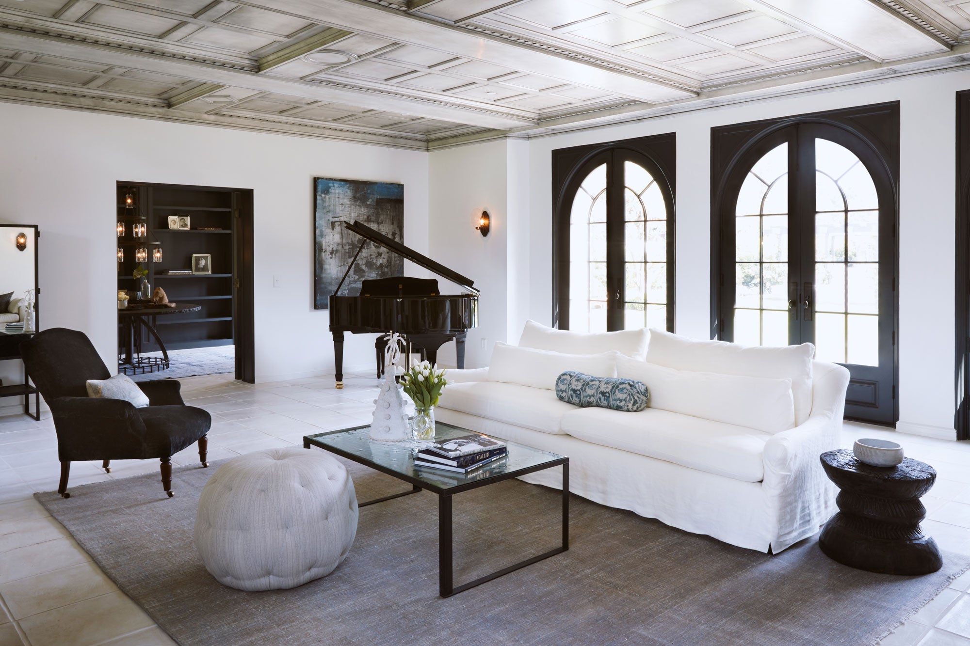 living room with white sofa, lounge chair and grand piano