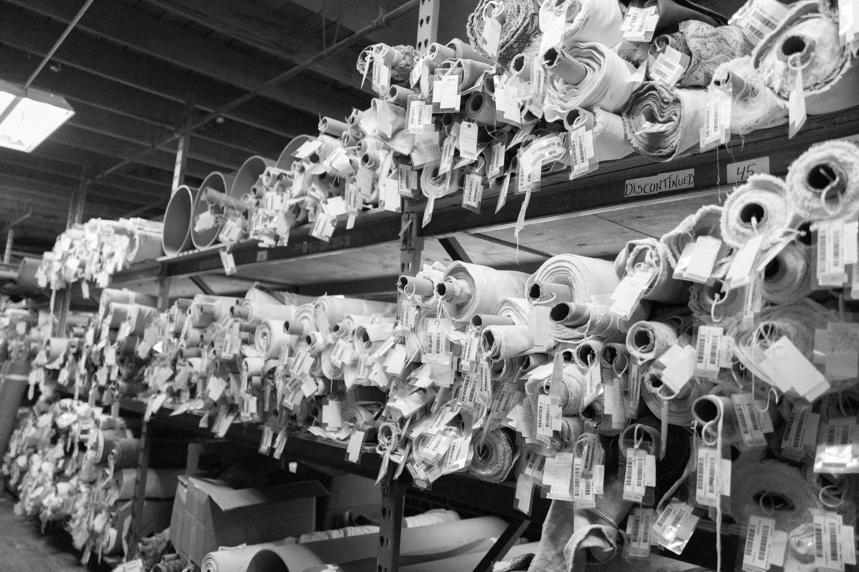 black and white image of fabric on rolls