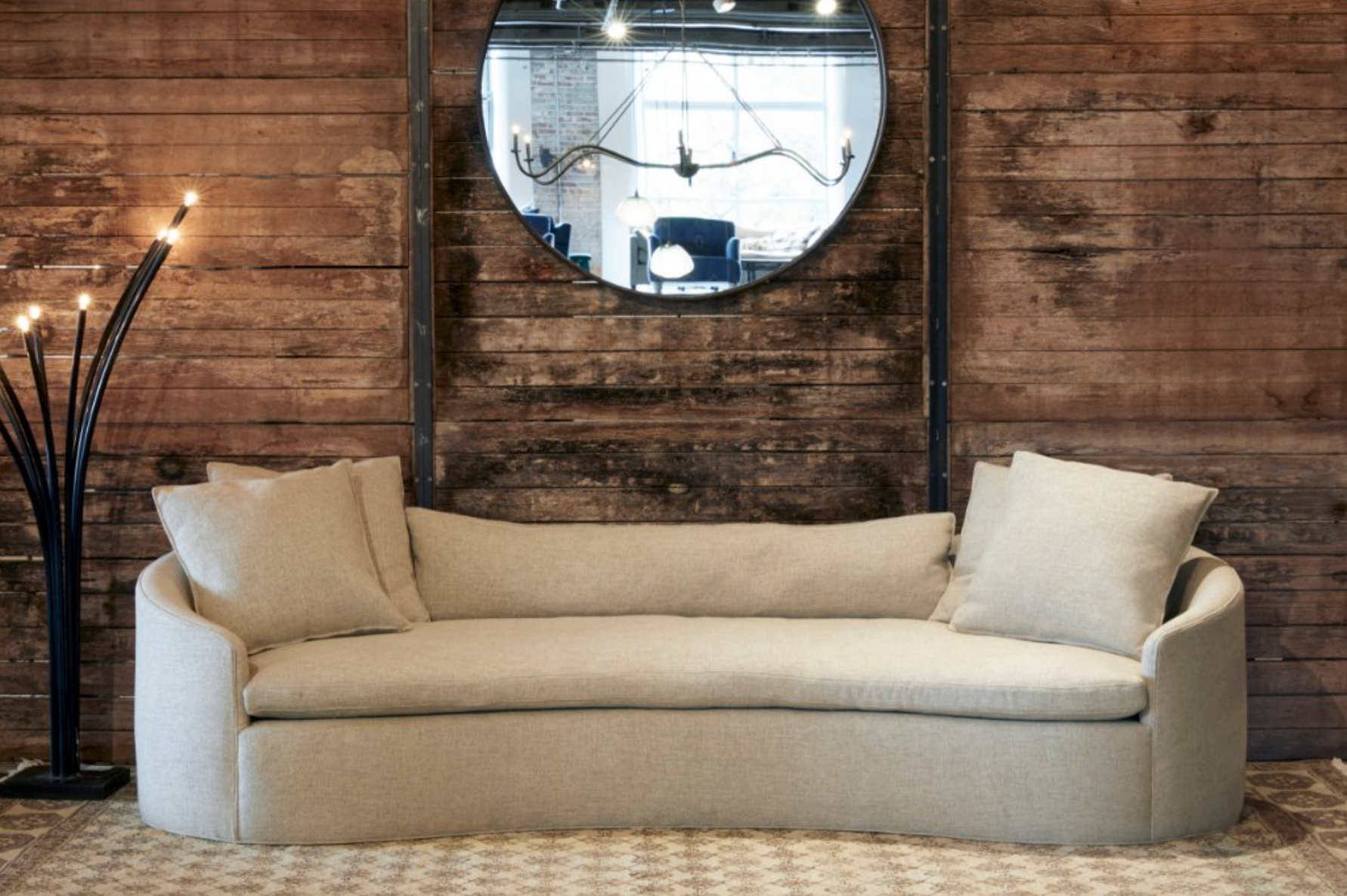 interior with light brown sofa and mirror in the center