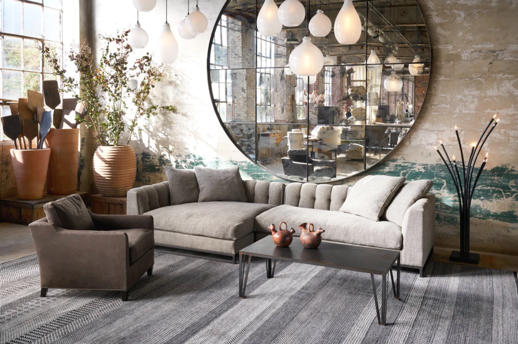 Interior with blue sofa and large wood and metal coffee table