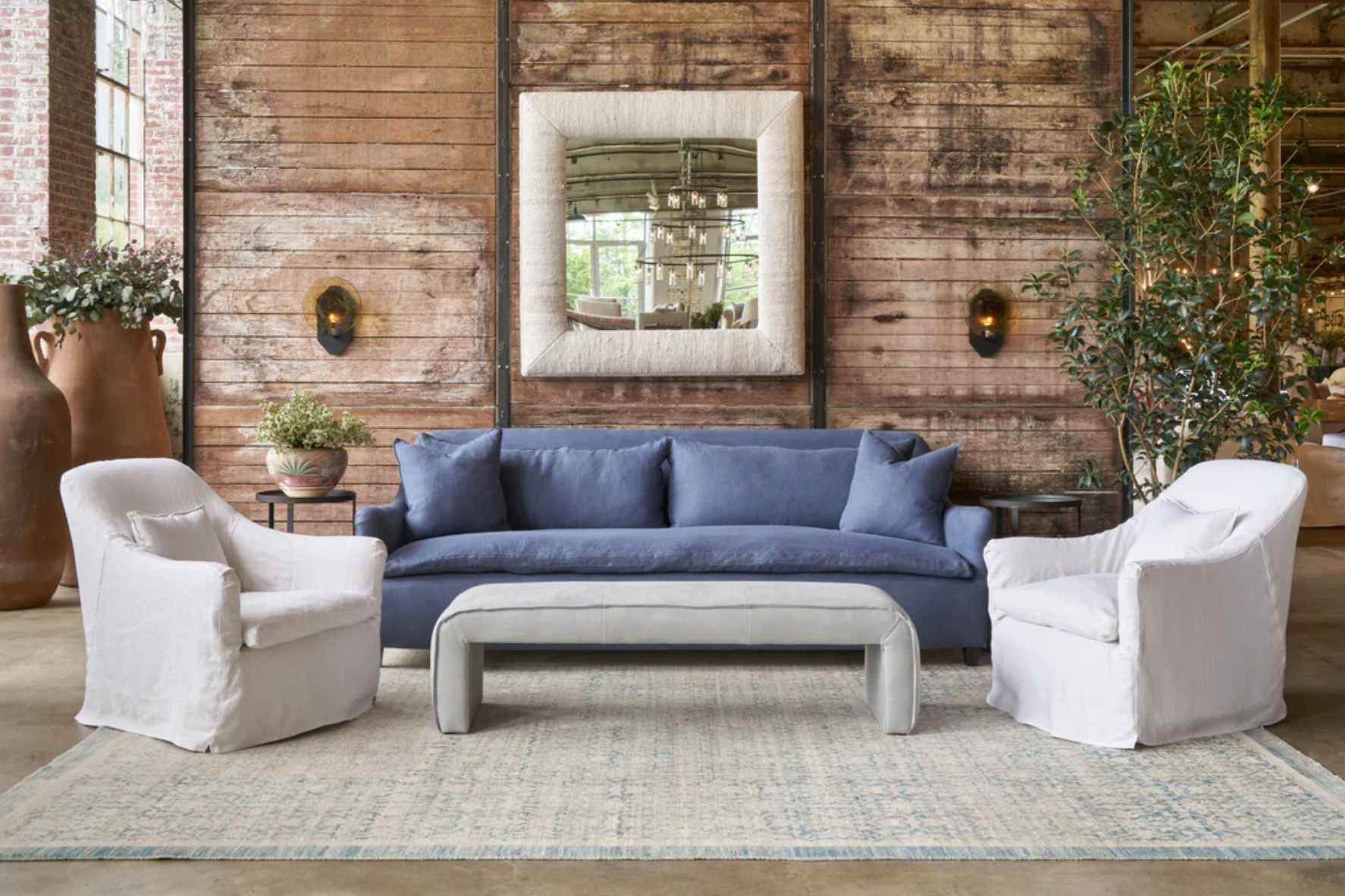 Interior with blue sofa and large wood and metal coffee table