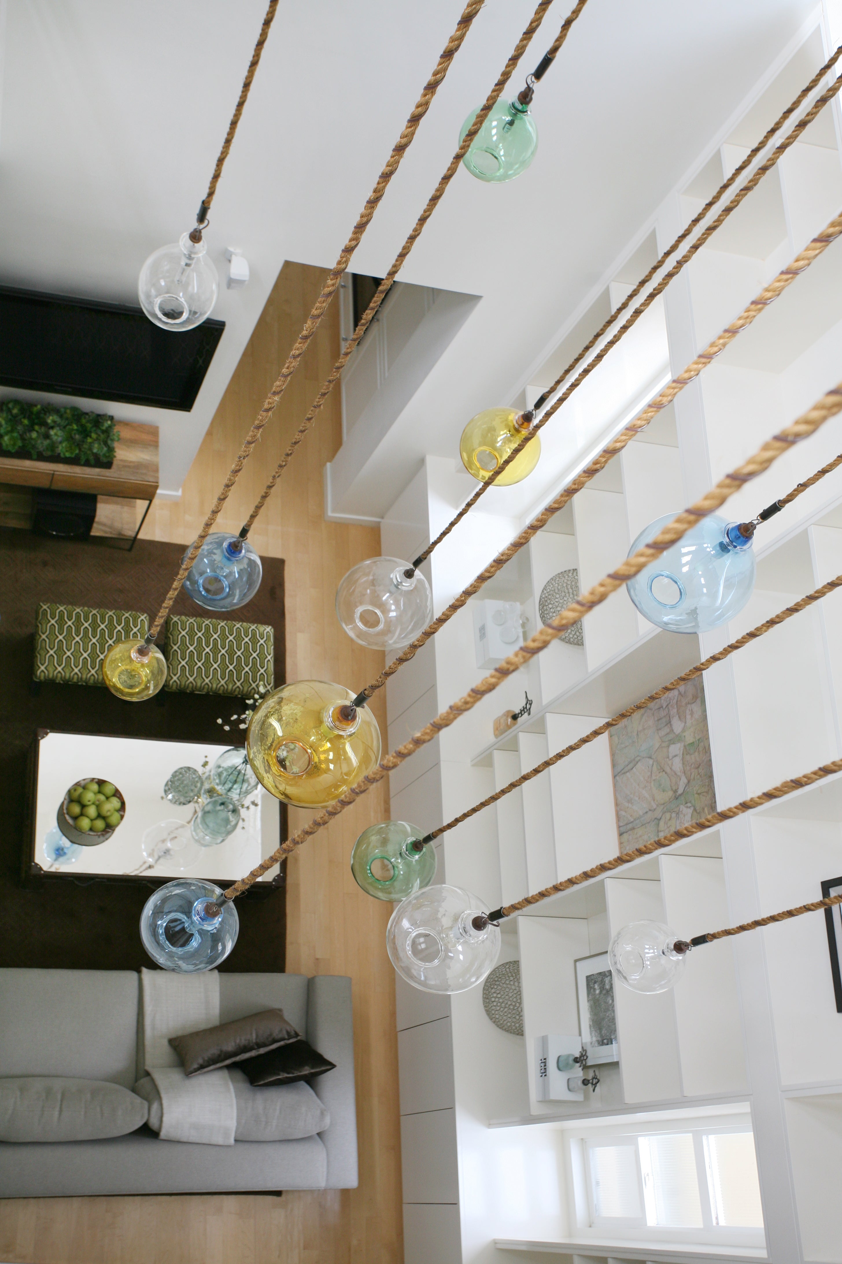 Hand blown glass jugs cluster seen from above looking down on a living room