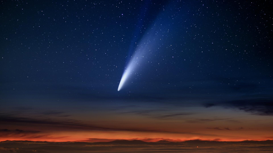 a comet streaks through the night sky