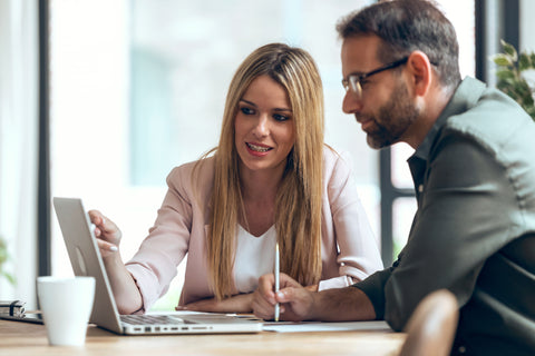 Male and female looking at a laptop screen