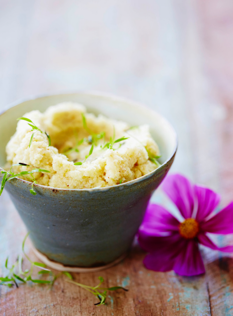 A bowl of food with a decorative flower on top