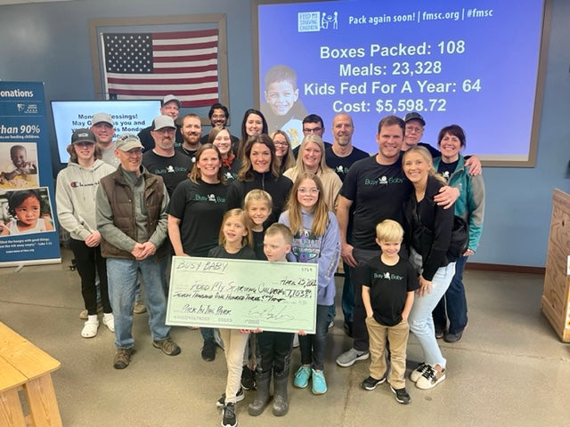 Busy Baby Volunteers and donation check for Feed My Starving Children