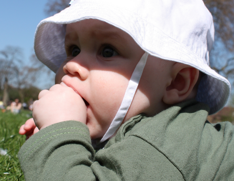 Baby outside with sunhat