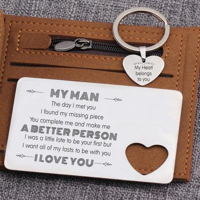 Engraved wallet card and heart keychain set on top of a wallet