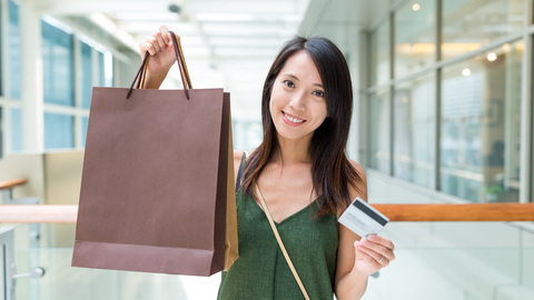 Girl holding gift card and bag