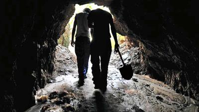 Men walking out of mining shaft