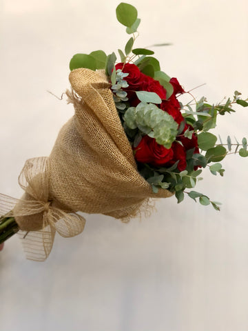 A dozen red roses wrapped bouquet