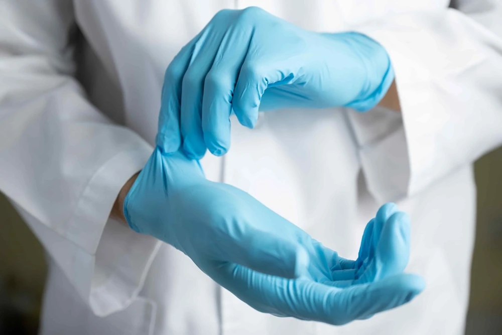 a doctor wearing gloves during a procedure