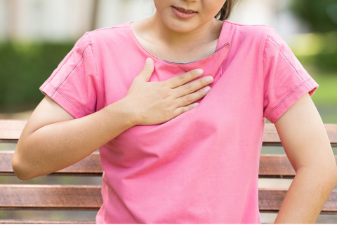 A woman holding her chest due to chest congestion