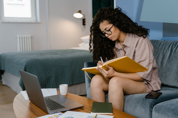 A focused woman typing on a computer