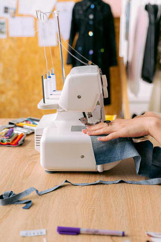 woman hemming bootcut jeans