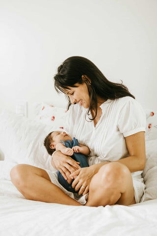 woman postpartum holding baby