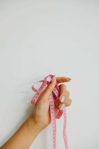 woman with pink measuring tape