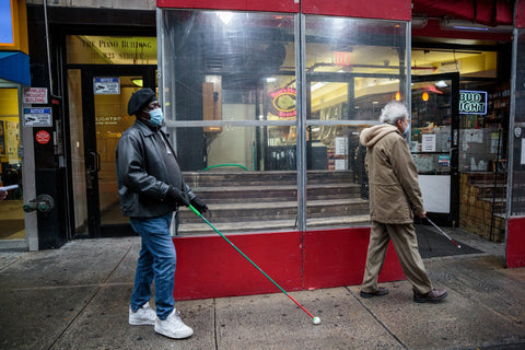 Blind men using canes on NYC street