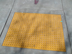 truncated domes ADA warning tiles embedded in sidewalk