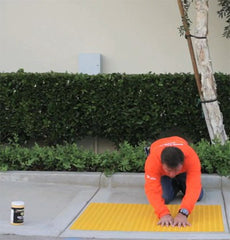 Smoothing air bubbles out from self-adhesive truncated domes mat