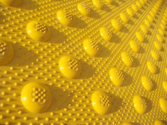 Closeup photo of non-skid pattern used on truncated domes tactile warning tiles and ADA pads