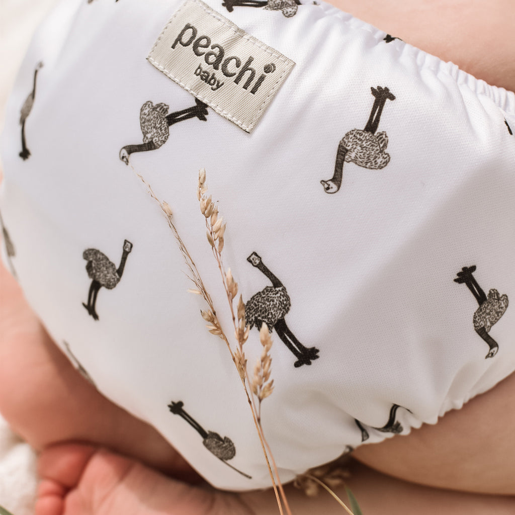Baby wearing a Reusable Nappy in an Ostrich print by Peachi Baby