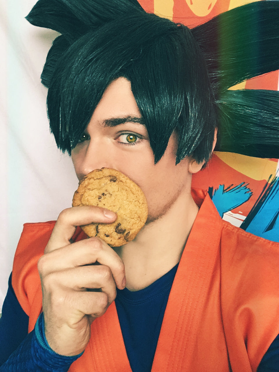 Goku cosplay from Dragon Ball Z holding a cookie