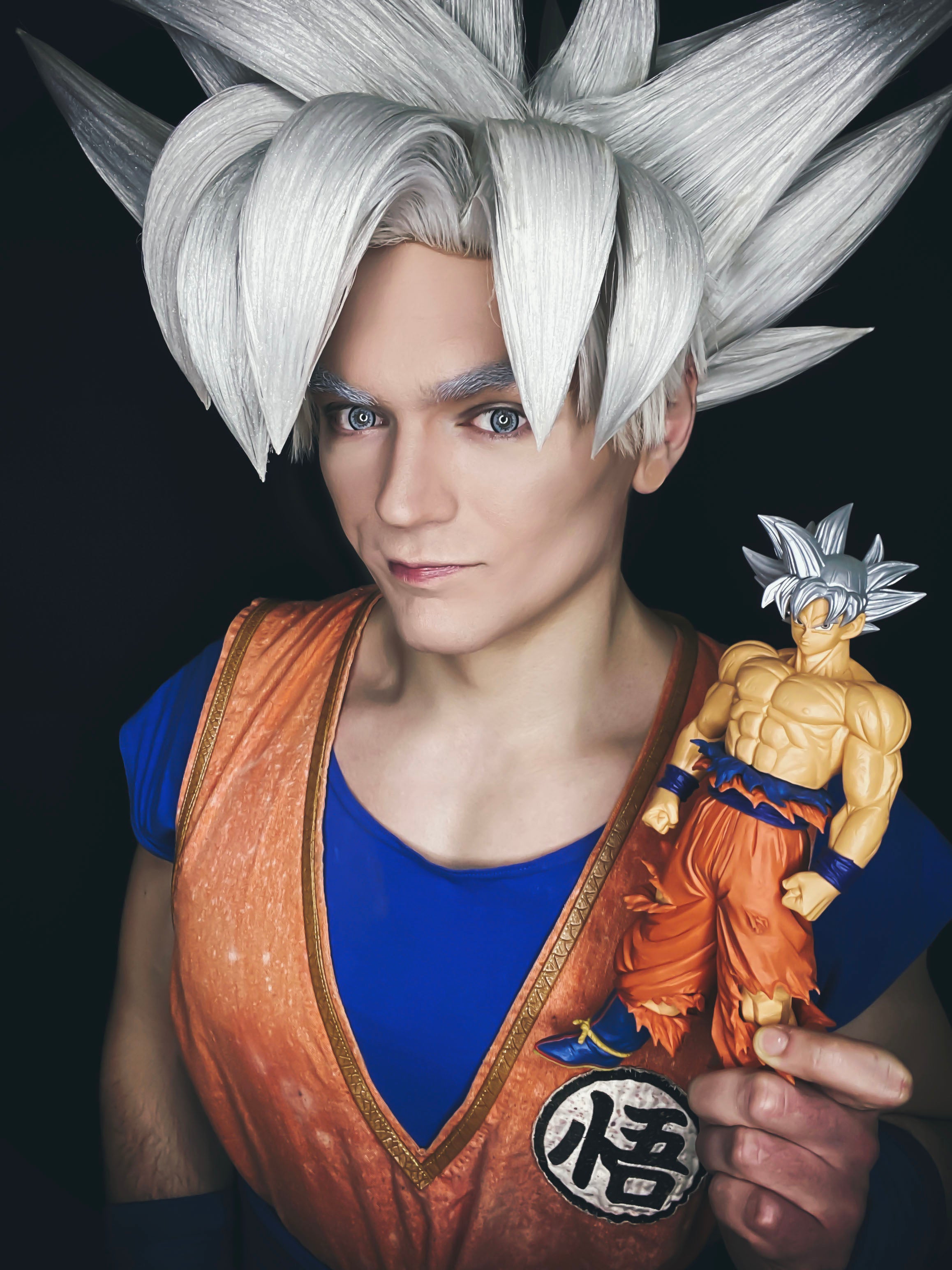 Mastered Ultra Instinct Goku cosplayer from DragonBall Super Holding A UI Goku Figure