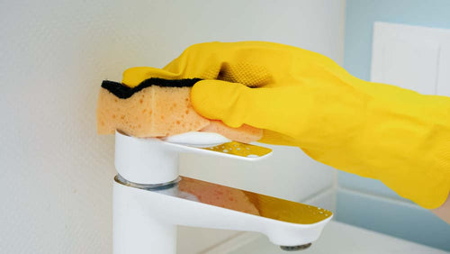 coseup-of-hand-wearing-yellow-rubber-glove-washing-2021-12-09-21-21-06-utc.jpg__PID:39b3454d-37cb-4fb4-bb8d-9f6207d08fd3