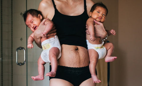 image of mother holding twins