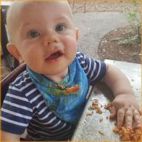 baby with bandana bib