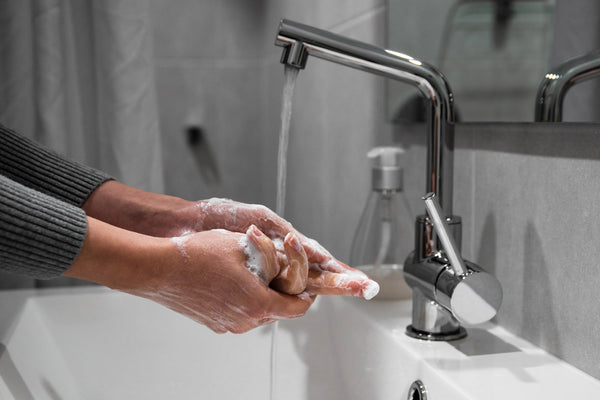 Woman washing hands in sink