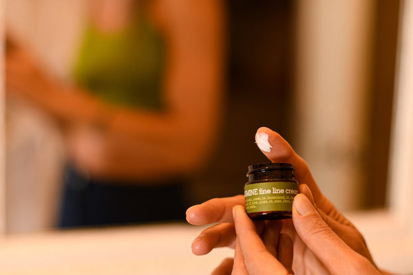 Woman applying Jasmine Fine Line Cream