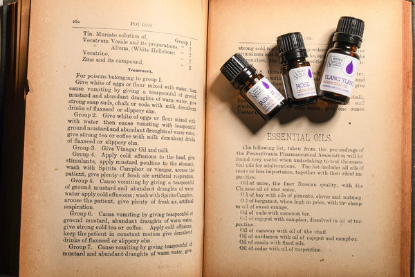 Three essential oils on an old book