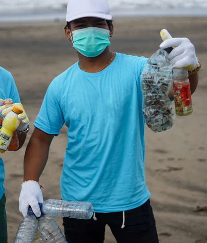 man holding plastic from the ocean