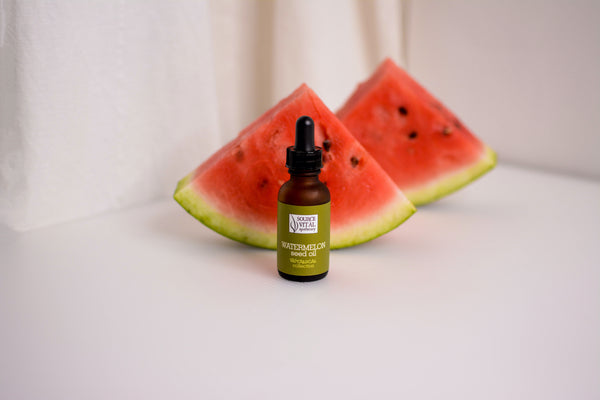 Source Vital Apothecary Watermelon Seed Oil against watermelon slices