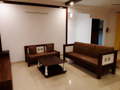 Living room with two CustHum-made wooden sofas, wooden farmhouse coffee table