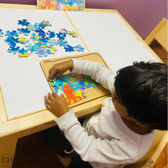 Child solving puzzle on CustHum activity table