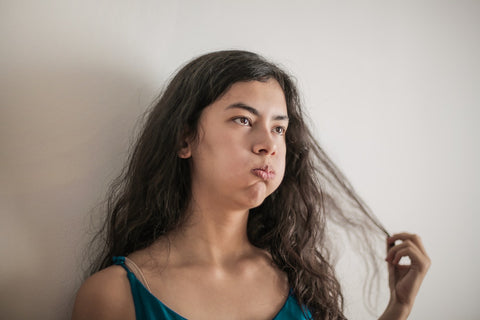 Distressed woman touching her hair