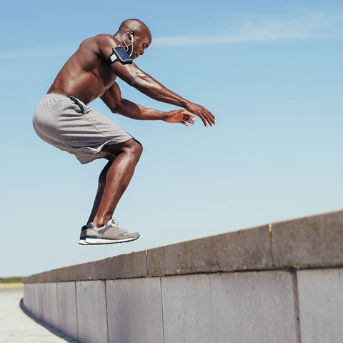 man jumping on a cement bench