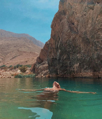 Naked woman swimming in the sea