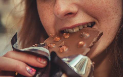 Woman eating chocolate bar product snack
