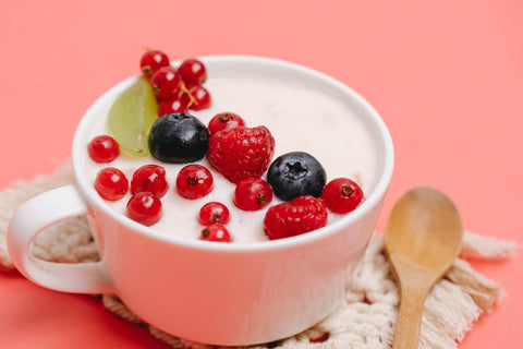 Yogurt and berries in a teacup bowl
