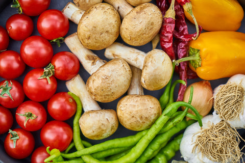 Close up of tomatoes, mushrooms, peppers and other vegetables