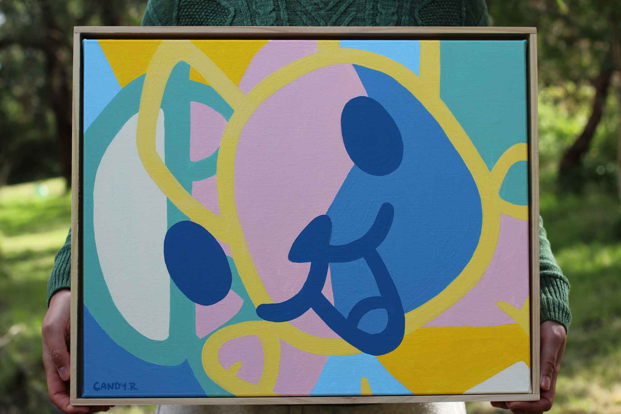 Abstract painting on canvas using bold pastel colours by Candy Robertson. The shapes are formed by different sections of the character Roobee Roo. It is a happy painting with a large smiling face being the dominant image.