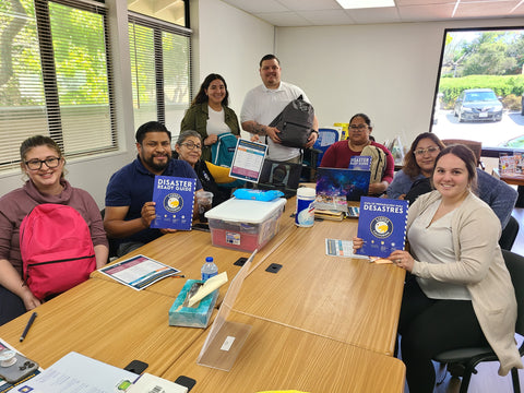 "Image showing Special Kids Connect team members reviewing the Disaster Ready Guide and preparing their own emergency Go Bags as part of their commitment to community resilience